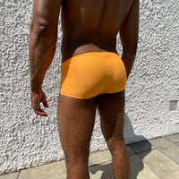 Vue de dos d'un homme portant le boxer shorty de bain Le Beau Tom, la marque de sous-vêtements et de maillots de bain.